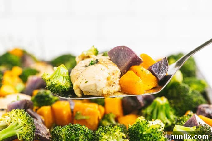Roasted One-Pan Maple Dijon Chicken with golden squash and potatoes, and bright green broccoli florets.