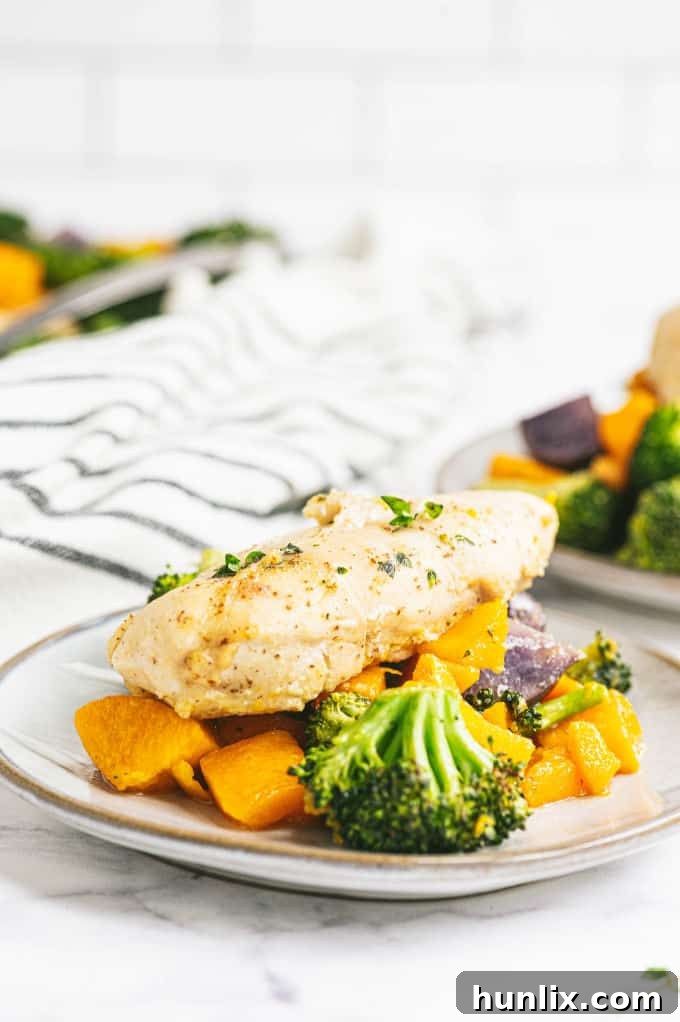 A generous drizzle of golden maple syrup over cooked chicken and vegetables, highlighting the delicious glaze.