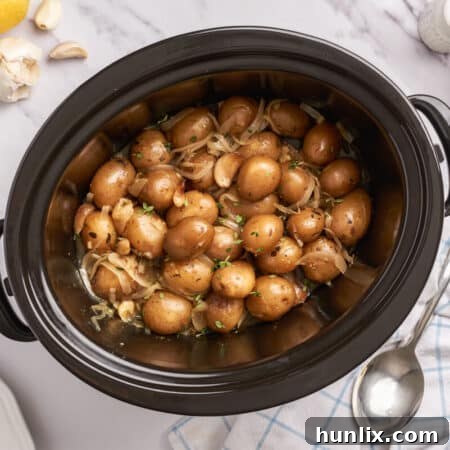 Garlic-Infused Slow Cooker Potatoes 8 Garlic potatoes in a slow cooker.