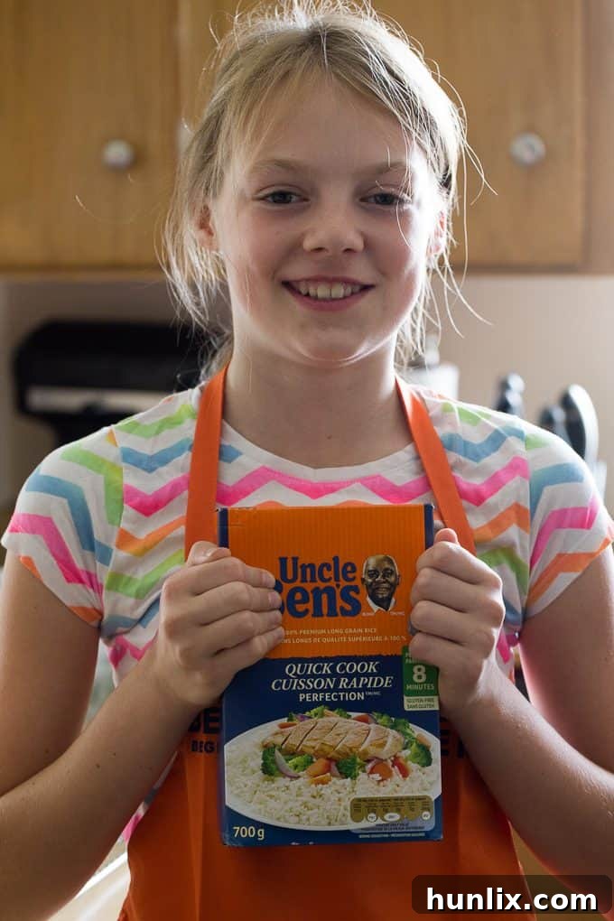 A young girl, Bridget, happily stirring ingredients for meatballs, part of a Ben's Beginners cooking lesson.