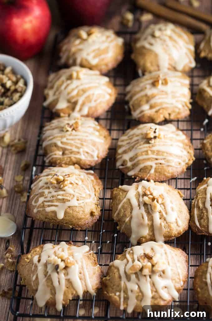Hand drizzling rich caramel glaze over perfectly baked Caramel Apple Cookies, ready to be enjoyed.