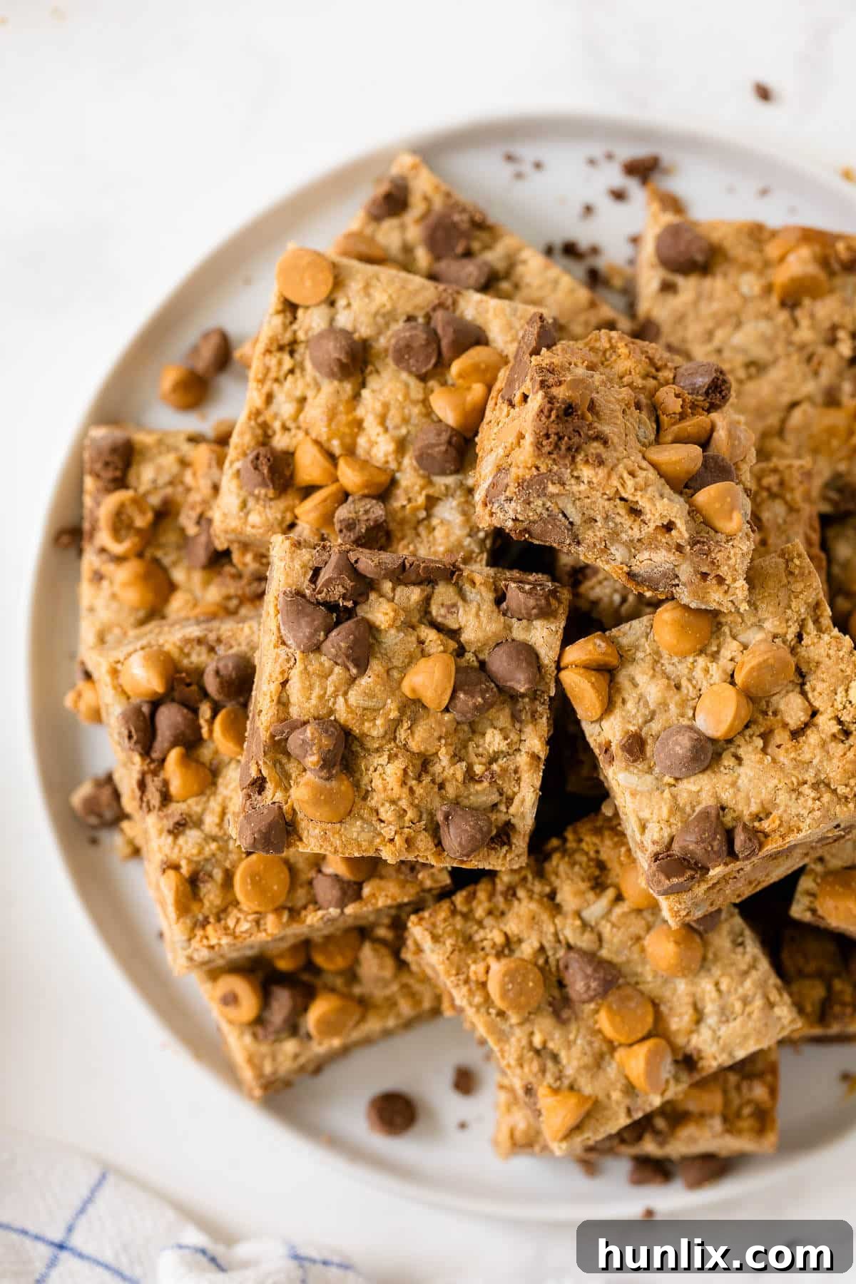 A single chewy bar on a white plate, showcasing its texture.