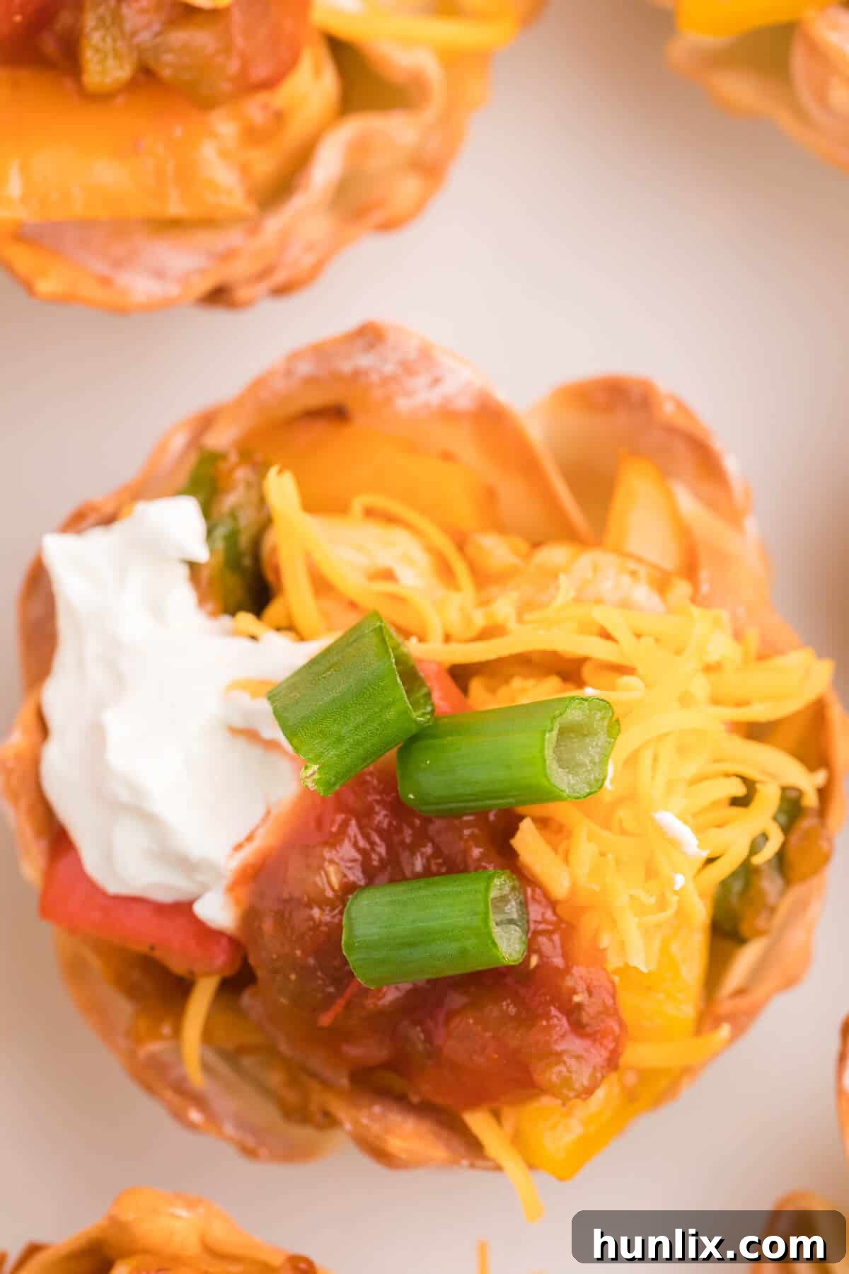 Chicken Fajita Wonton Cups - A little East, a little West. These appetizer cups are perfect for entertaining with a festive Mexican filling in a crunchy wonton.
