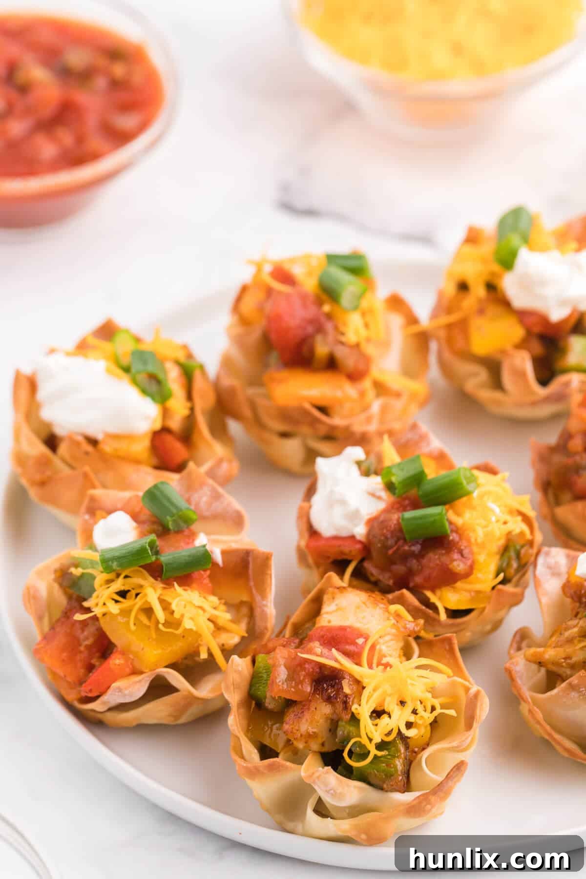 Chicken Fajita Wonton Cups - A little East, a little West. These appetizer cups are perfect for entertaining with a festive Mexican filling in a crunchy wonton.