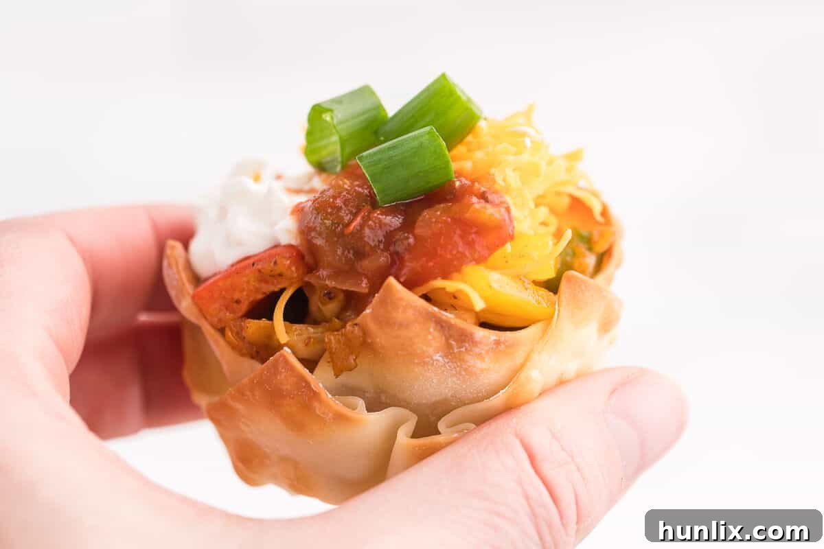 Chicken Fajita Wonton Cups - A little East, a little West. These appetizer cups are perfect for entertaining with a festive Mexican filling in a crunchy wonton.
