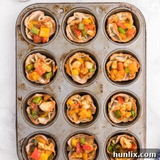 Chicken Fajita Wonton Cups - A little East, a little West. These appetizer cups are perfect for entertaining with a festive Mexican filling in a crunchy wonton.