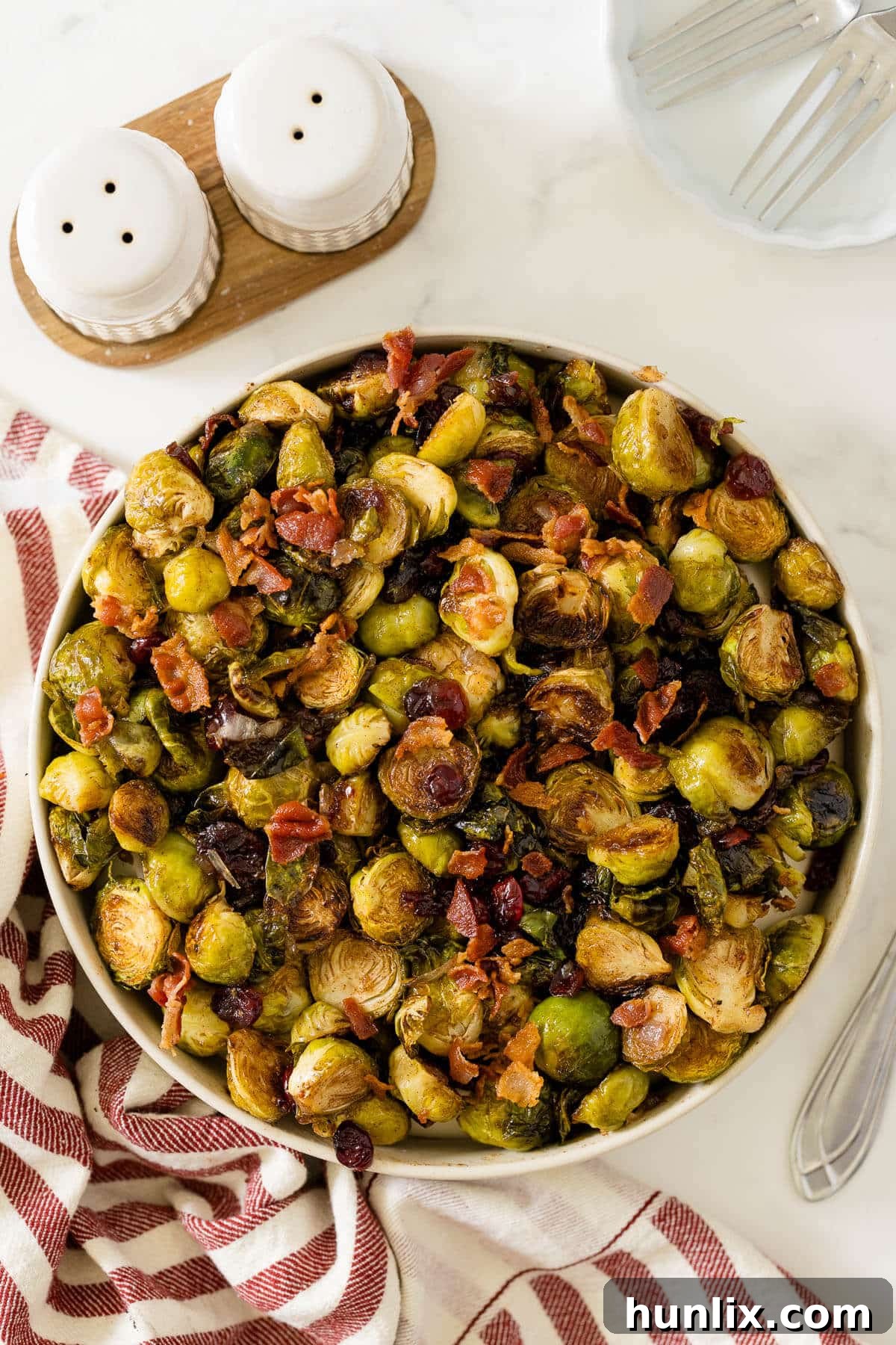 Crispy Bacon Cranberry Roasted Brussels 2 Roasted brussel sprouts in a bowl, ready to be served for a holiday dinner.