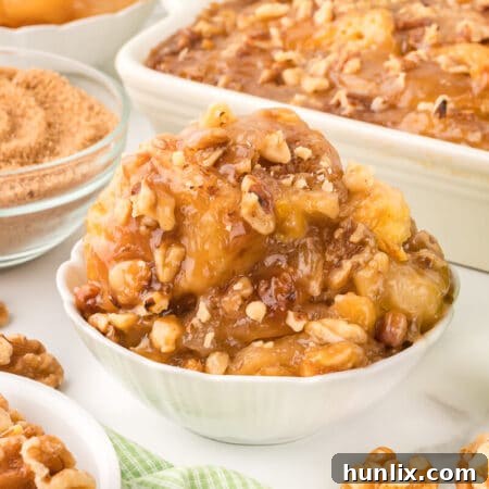 A beautiful close-up of a serving of Apple Butterscotch Buns in a white bowl, showing the rich butterscotch and apple filling.