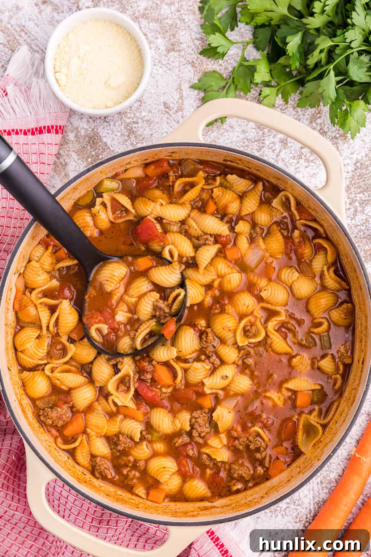 Hamburger soup in a pot with a ladle.