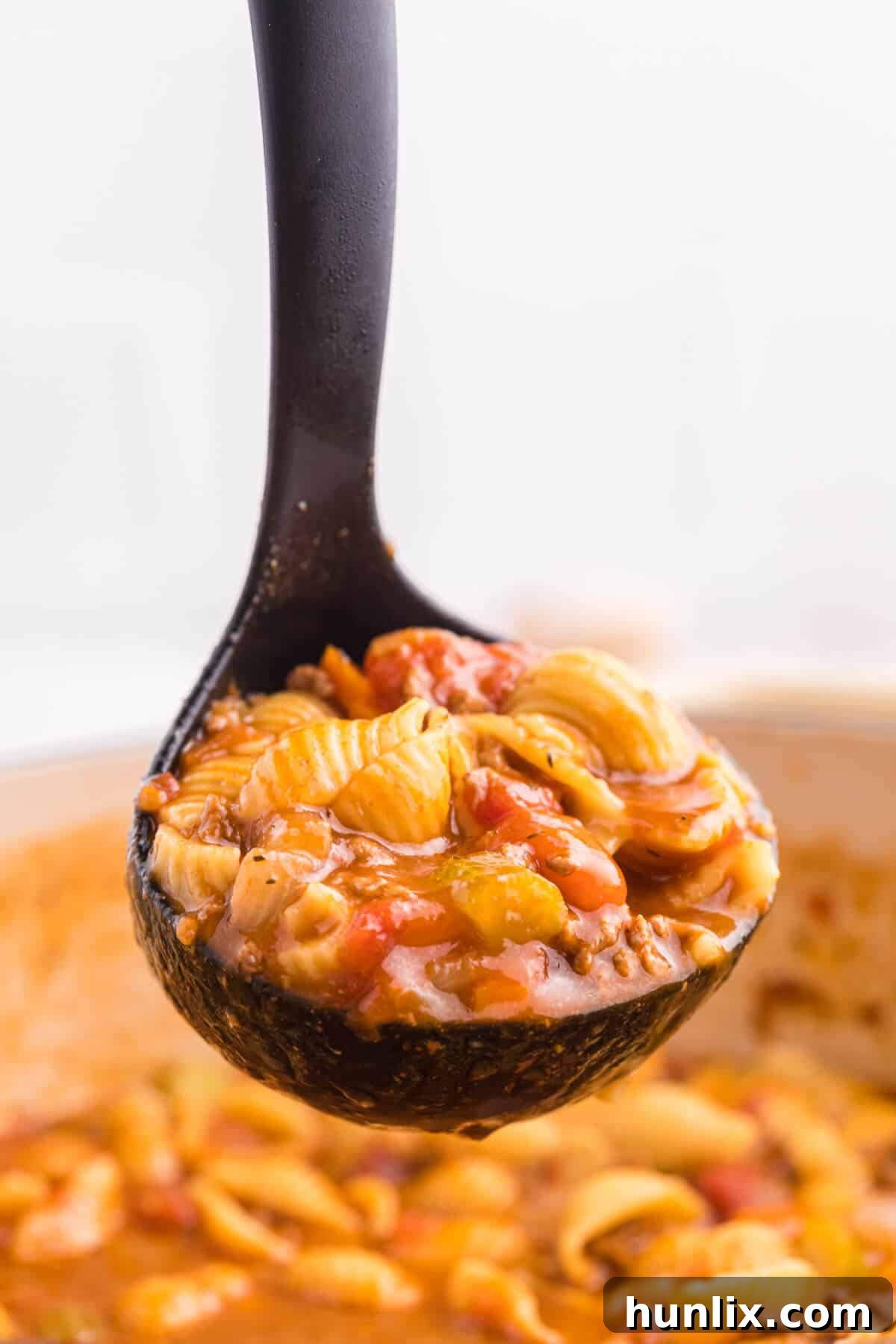 The soup in a black ladle.