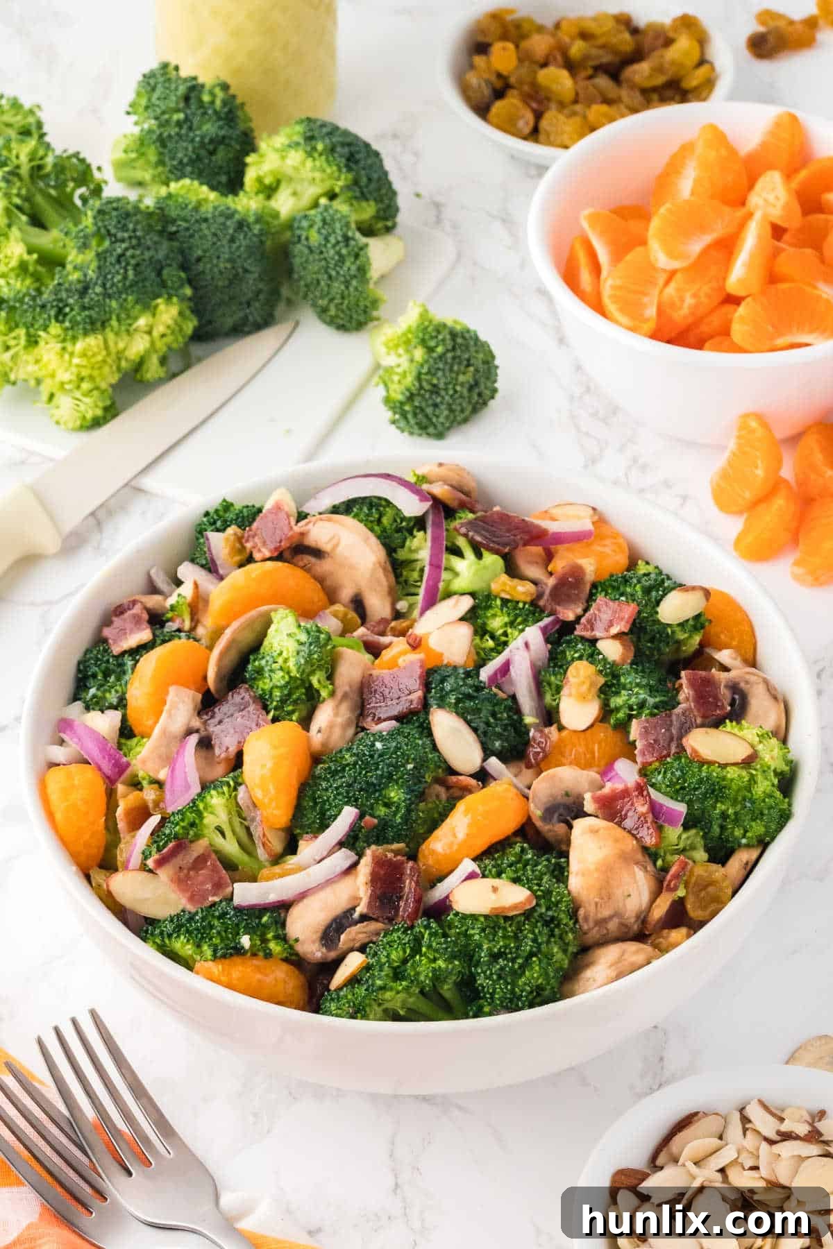 Creamy Broccoli Salad 7 A serving of broccoli salad in a white bowl, garnished.