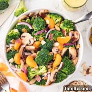 Creamy Broccoli Salad 10 Broccoli salad in a white bowl with a serving spoon.