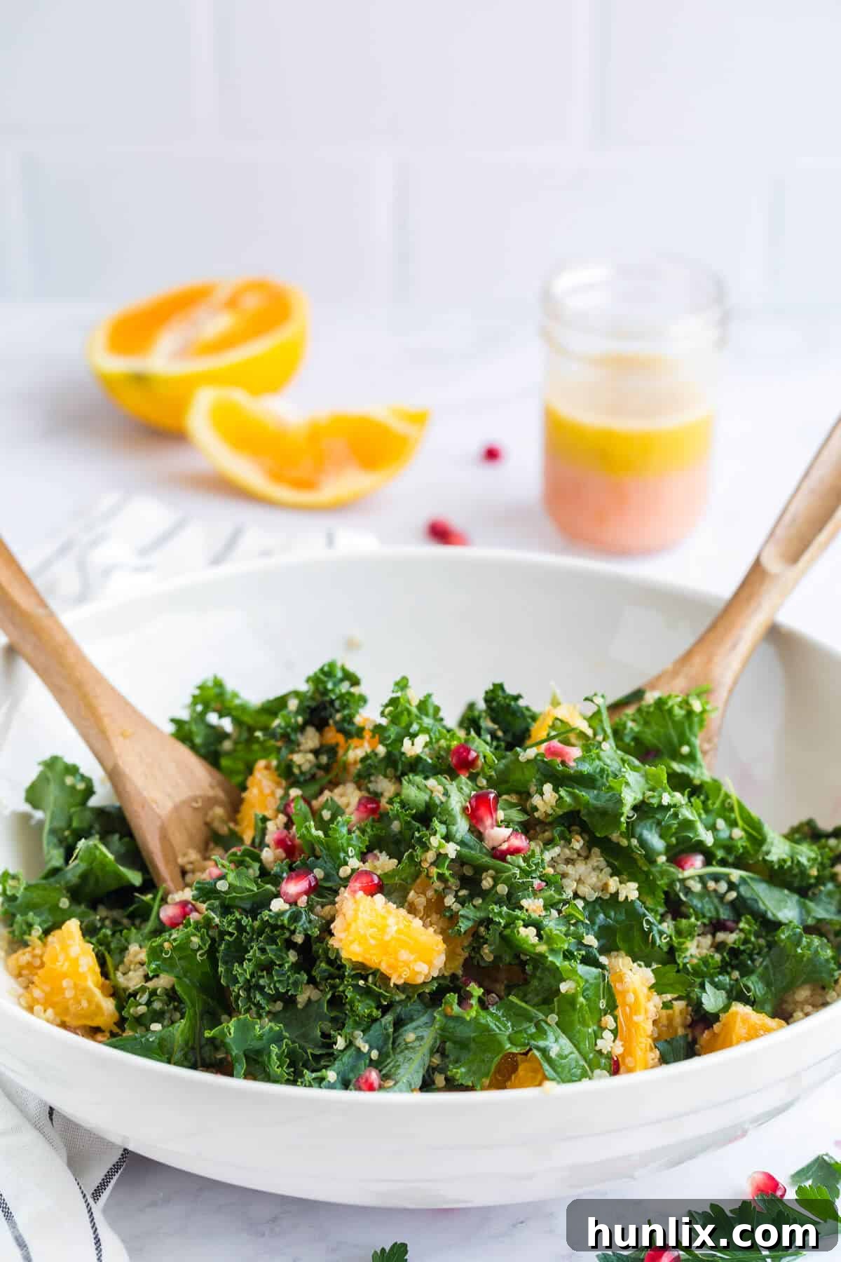 Nourishing Winter Reset Salad 3 A beautiful bowl of winter detox salad with elegant salad tongs, ready to serve.