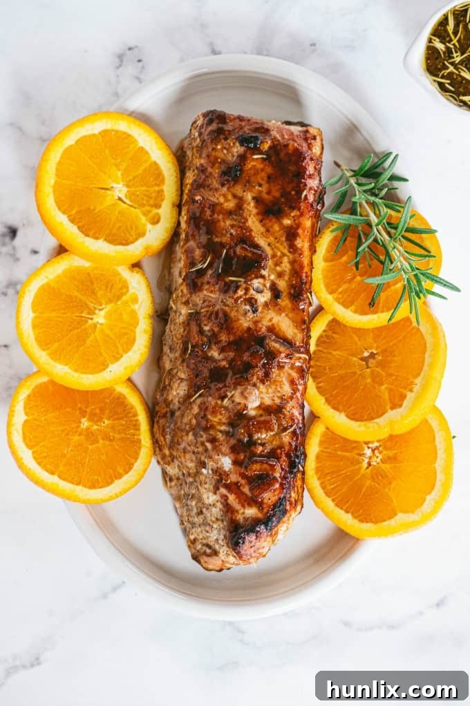 Orange Mustard Pork Tenderloin - This easy glazed tenderloin recipe is sweet and savory with orange juice and stone ground mustard. You'll never have a dry piece of pork with this homemade marinade.