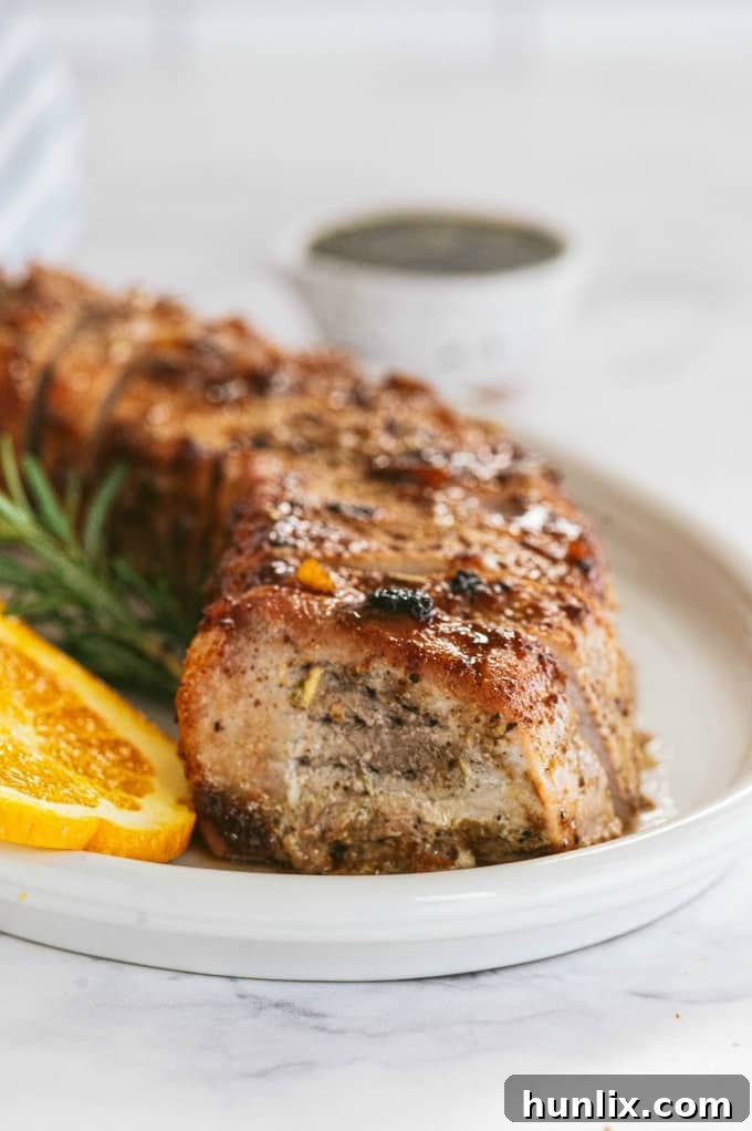 Orange Mustard Pork Tenderloin - This easy glazed tenderloin recipe is sweet and savory with orange juice and stone ground mustard. You'll never have a dry piece of pork with this homemade marinade.