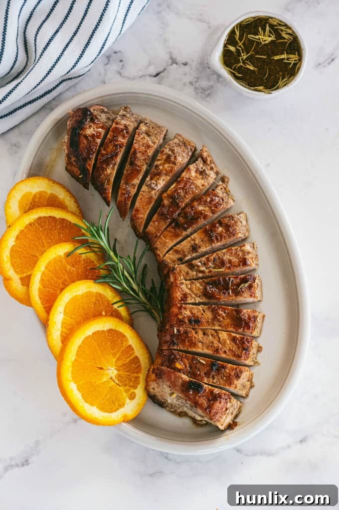 Orange Mustard Pork Tenderloin - This easy glazed tenderloin recipe is sweet and savory with orange juice and stone ground mustard. You'll never have a dry piece of pork with this homemade marinade.