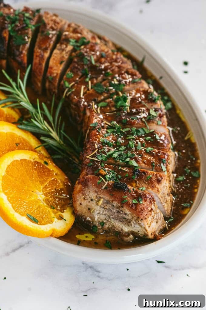 Orange Mustard Pork Tenderloin - This easy glazed tenderloin recipe is sweet and savory with orange juice and stone ground mustard. You'll never have a dry piece of pork with this homemade marinade.
