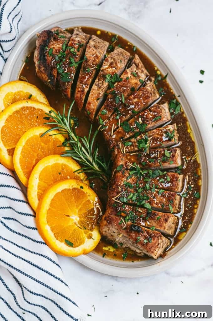 Orange Mustard Pork Tenderloin - This easy glazed tenderloin recipe is sweet and savory with orange juice and stone ground mustard. You'll never have a dry piece of pork with this homemade marinade.