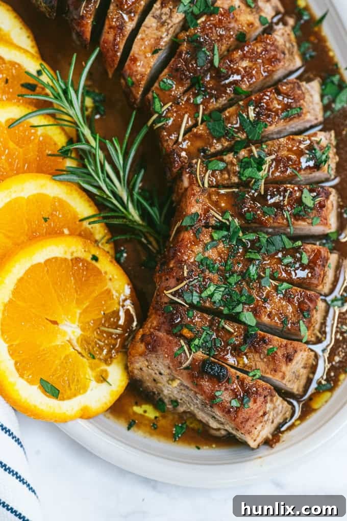 Orange Mustard Pork Tenderloin - This easy glazed tenderloin recipe is sweet and savory with orange juice and stone ground mustard. You'll never have a dry piece of pork with this homemade marinade.