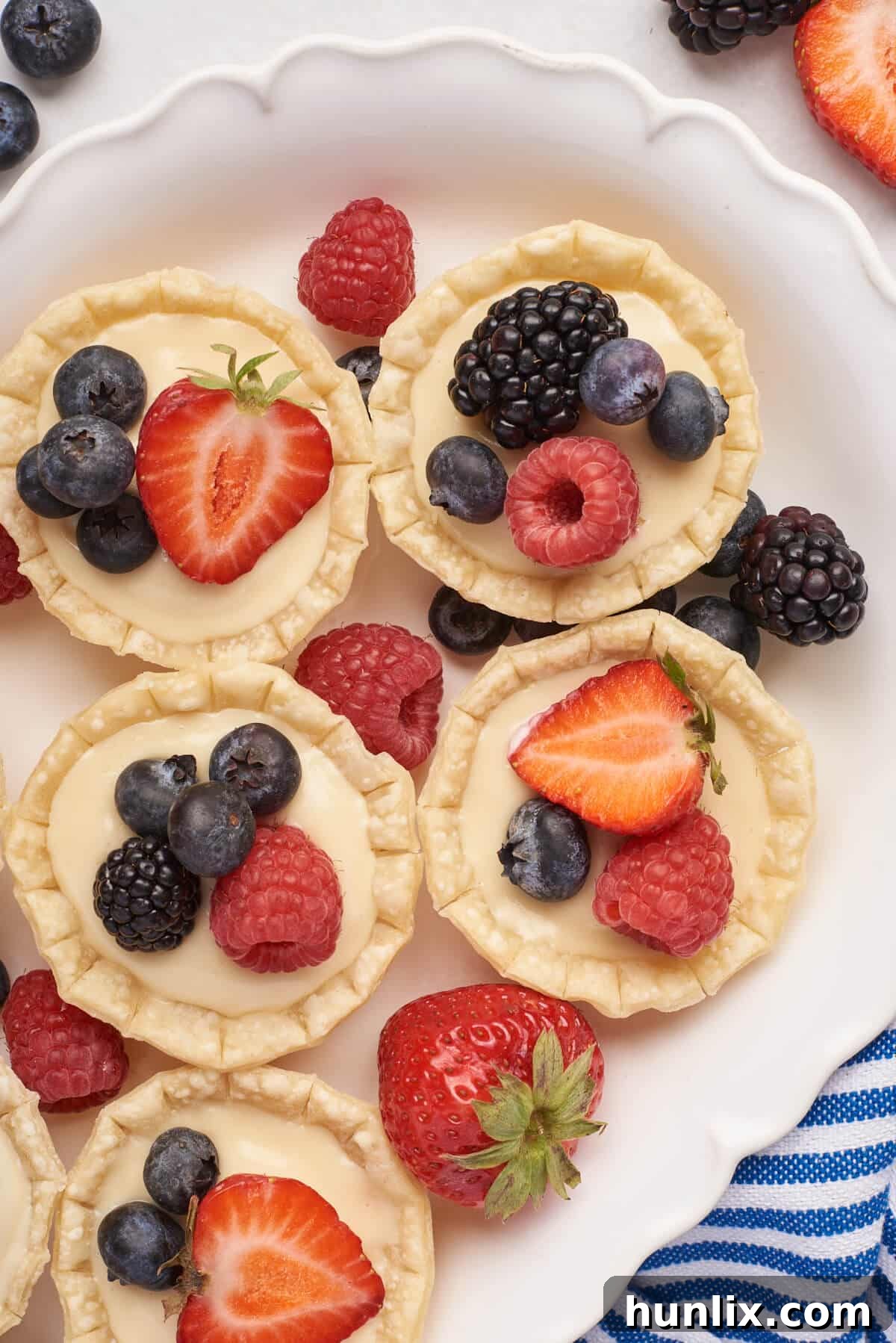 A vibrant platter of cream cheese fruit tarts, ready for serving.