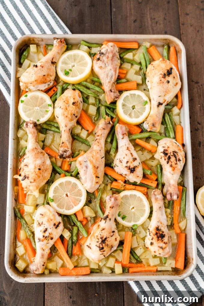 One-Pan Lemon Thyme Chicken - Tender, flavourful chicken drumsticks covered in a lemon/herb butter spread are roasted to perfection along with carrots, potatoes and green beans on one pan! You'll love how easy it is to make and clean.