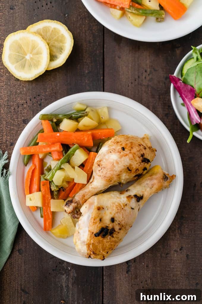 One-Pan Lemon Thyme Chicken - Tender, flavourful chicken drumsticks covered in a lemon/herb butter spread are roasted to perfection along with carrots, potatoes and green beans on one pan! You’ll love how easy it is to make and clean.