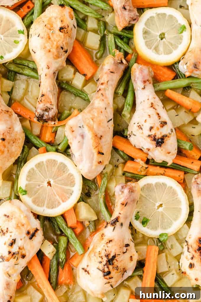 One-Pan Lemon Thyme Chicken - Tender, flavourful chicken drumsticks covered in a lemon/herb butter spread are roasted to perfection along with carrots, potatoes and green beans on one pan! You’ll love how easy it is to make and clean.