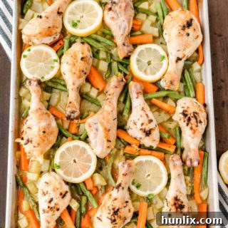 One-Pan Lemon Thyme Chicken - Tender, flavourful chicken drumsticks covered in a lemon/herb butter spread are roasted to perfection along with carrots, potatoes and green beans on one pan! You’ll love how easy it is to make and clean.