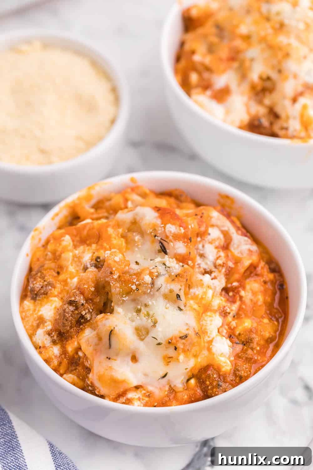 Portion of Lasagna Tater Tot Casserole with a fork, showing layers.