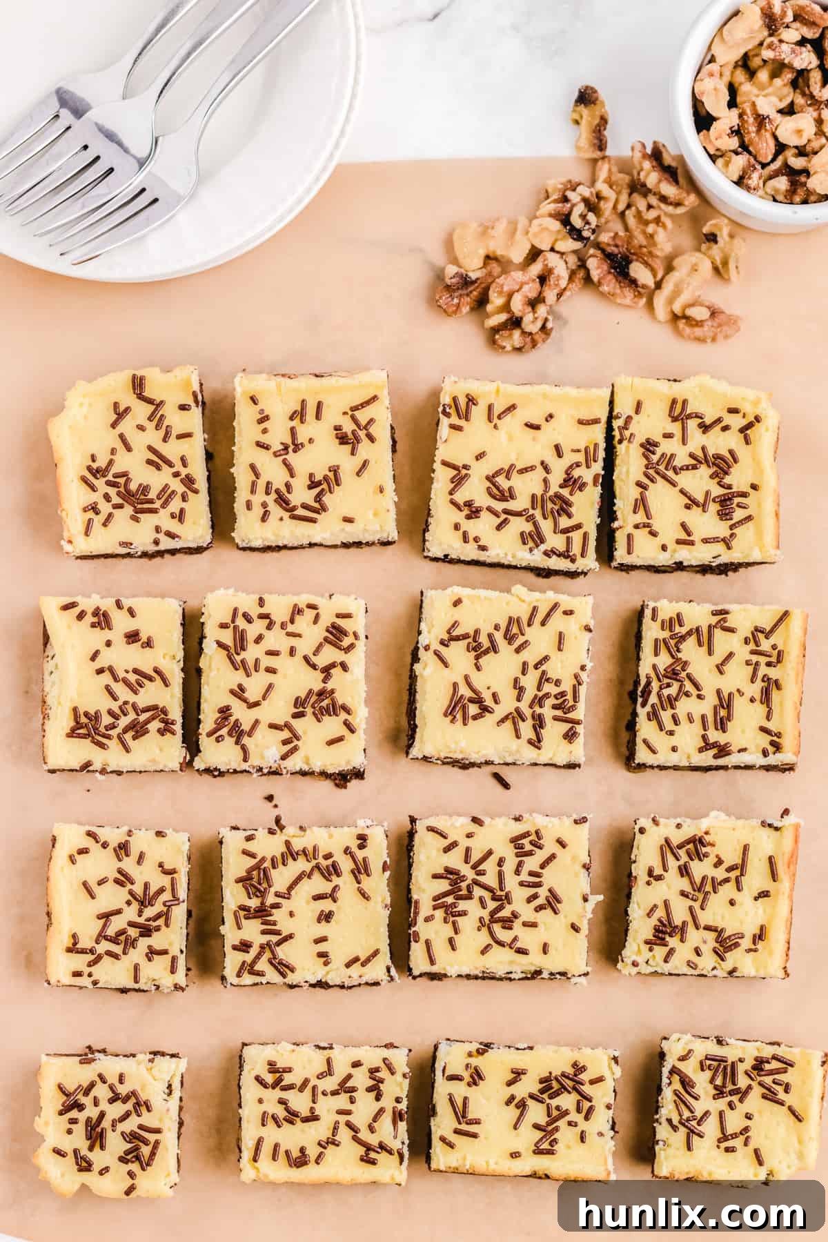 The finished cheesecake squares resting on parchment paper, ready to be cut.
