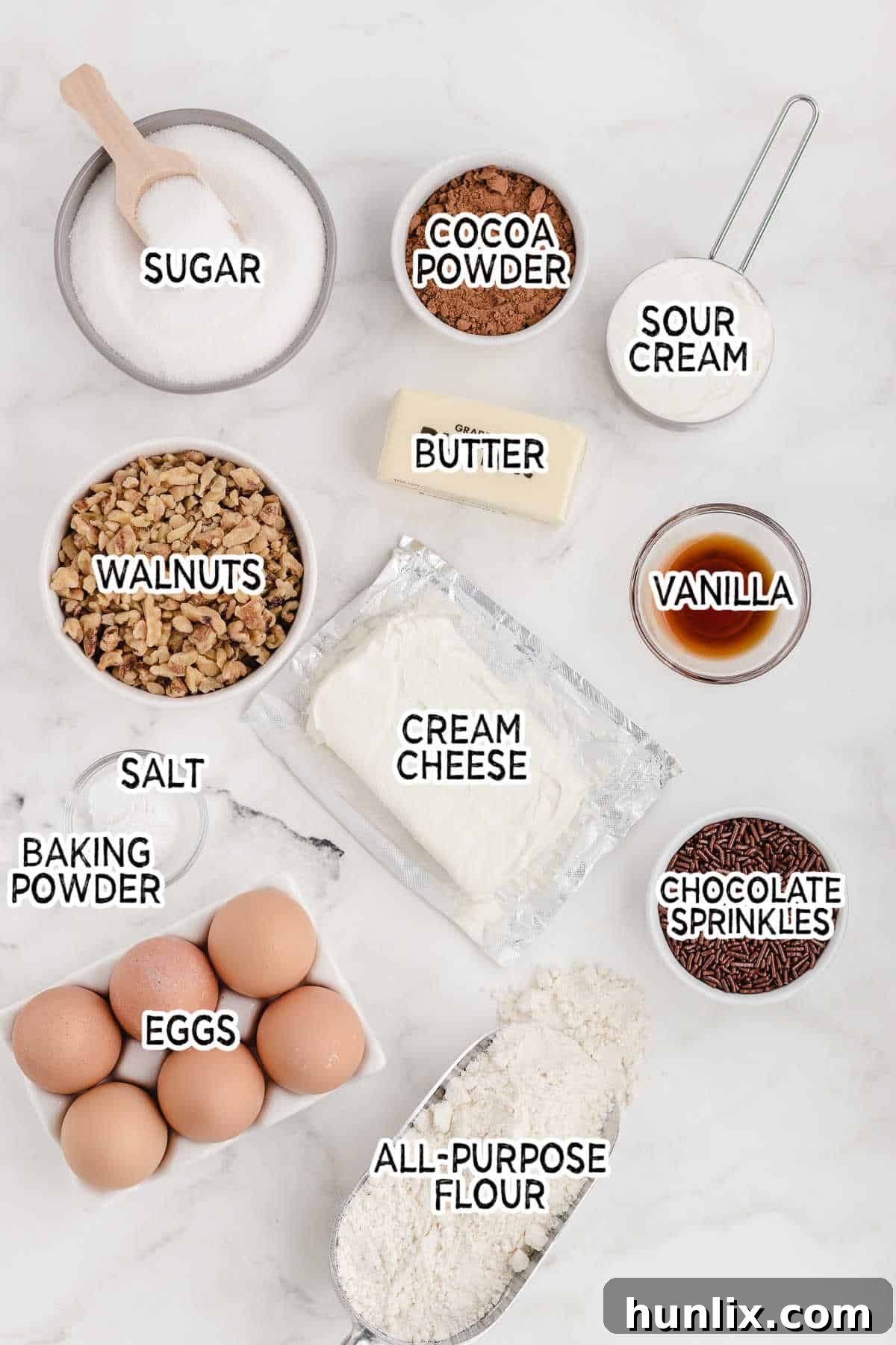 A beautiful array of cheesecake ingredients laid out on a marble counter, ready for baking.