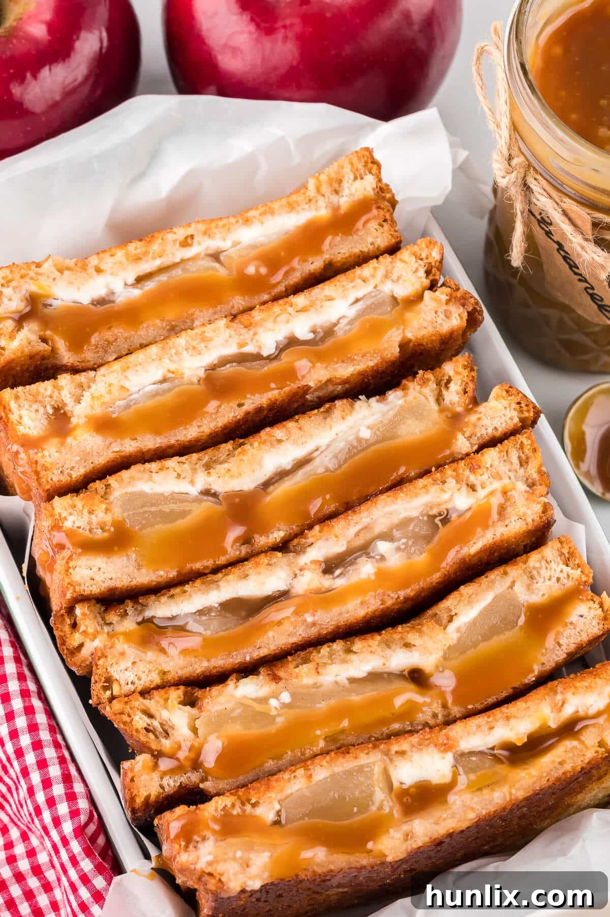 Sweet & Savory Caramel Apple Melt 6 Several caramel apple grilled cheese sandwiches cooking in a large pan, sizzling and turning golden brown.