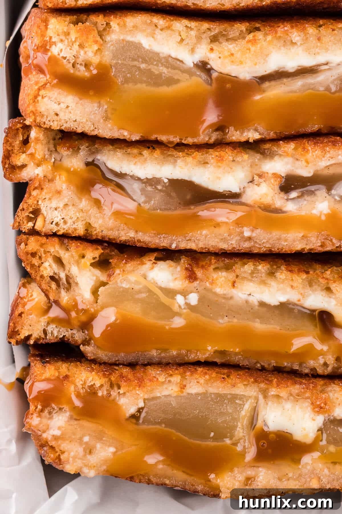 Sweet & Savory Caramel Apple Melt 7 A stack of delicious caramel apple grilled cheese sandwiches, showing the warm, inviting layers.