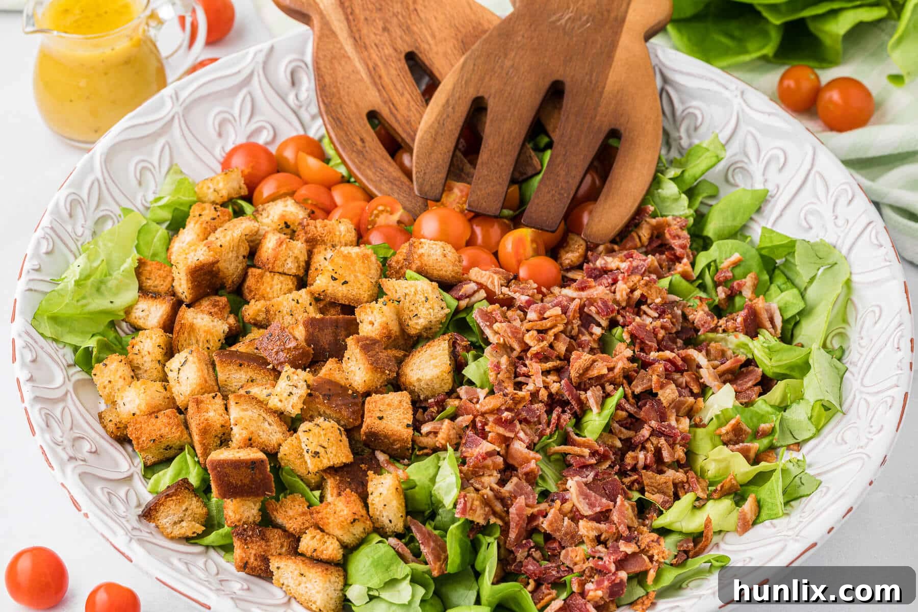 Deconstructed BLT Salad 2 BLT salad in a bowl with wooden salad tongs, ready to serve.