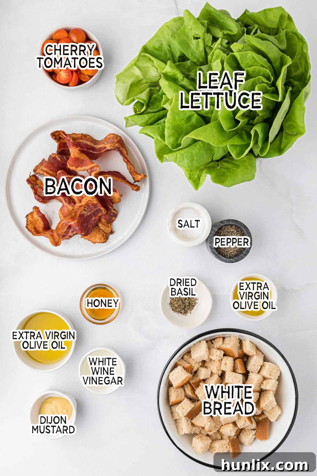 Deconstructed BLT Salad 3 Ingredients for making a BLT salad, including lettuce, tomatoes, bacon, bread, and dressing components.