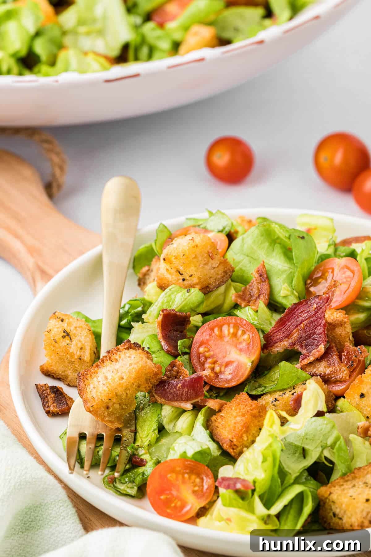 Deconstructed BLT Salad 9 BLT salad on a white plate, garnished and ready to eat.