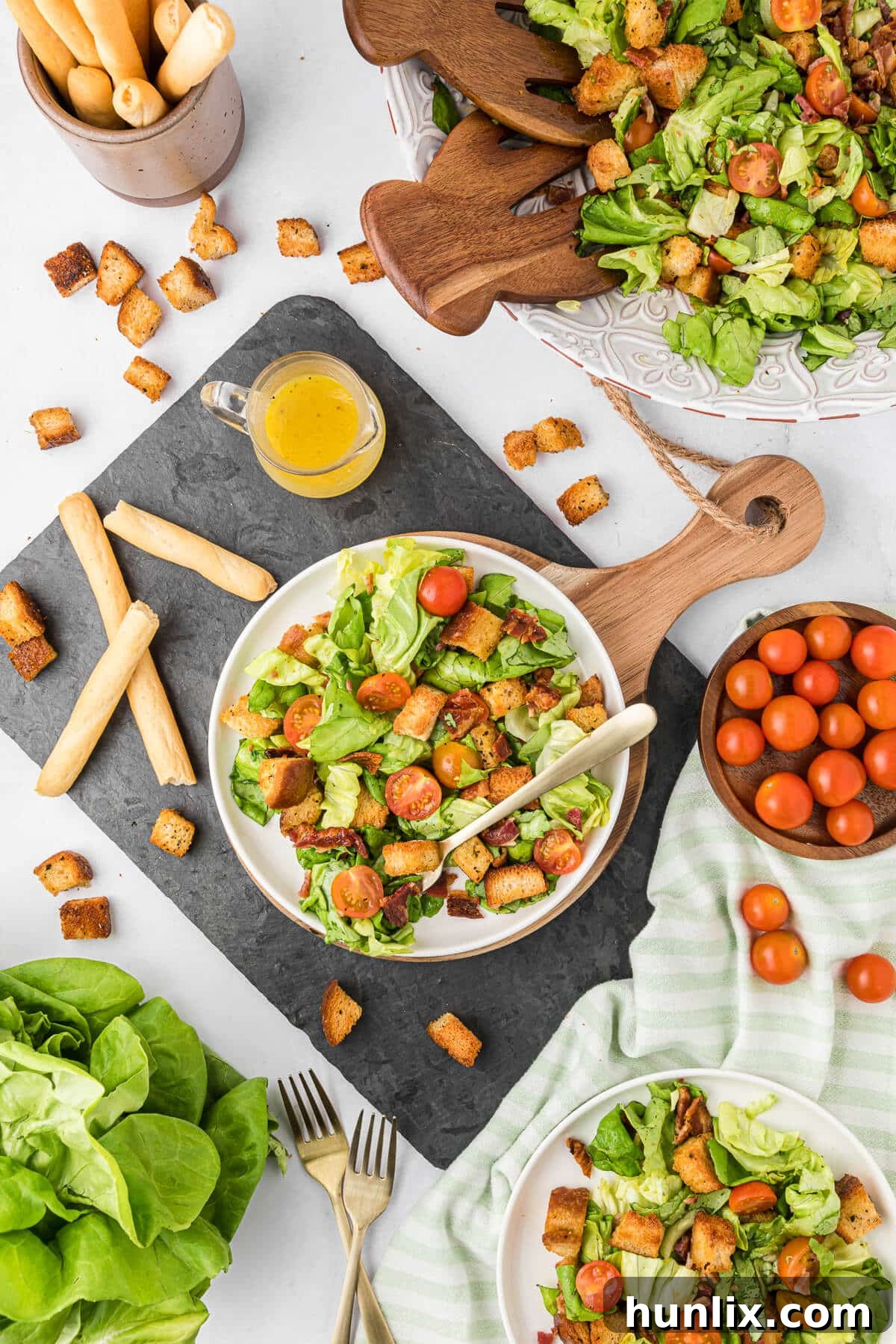 Deconstructed BLT Salad 10 BLT Salad on a plate, surrounded by fresh ingredients like lettuce, tomatoes, and bacon.