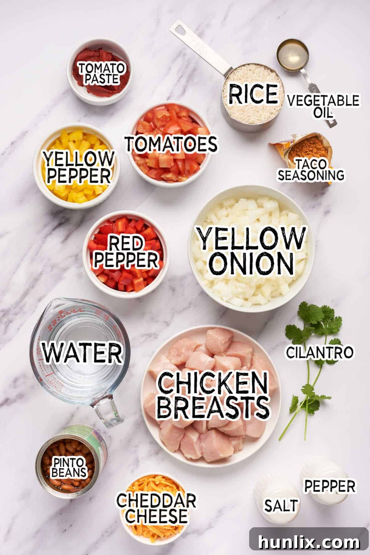 Skillet Chicken Burrito Fiesta 3 Collection of fresh ingredients for One-Pot Chicken Burrito Bowl, including vegetables, beans, chicken, and spices.