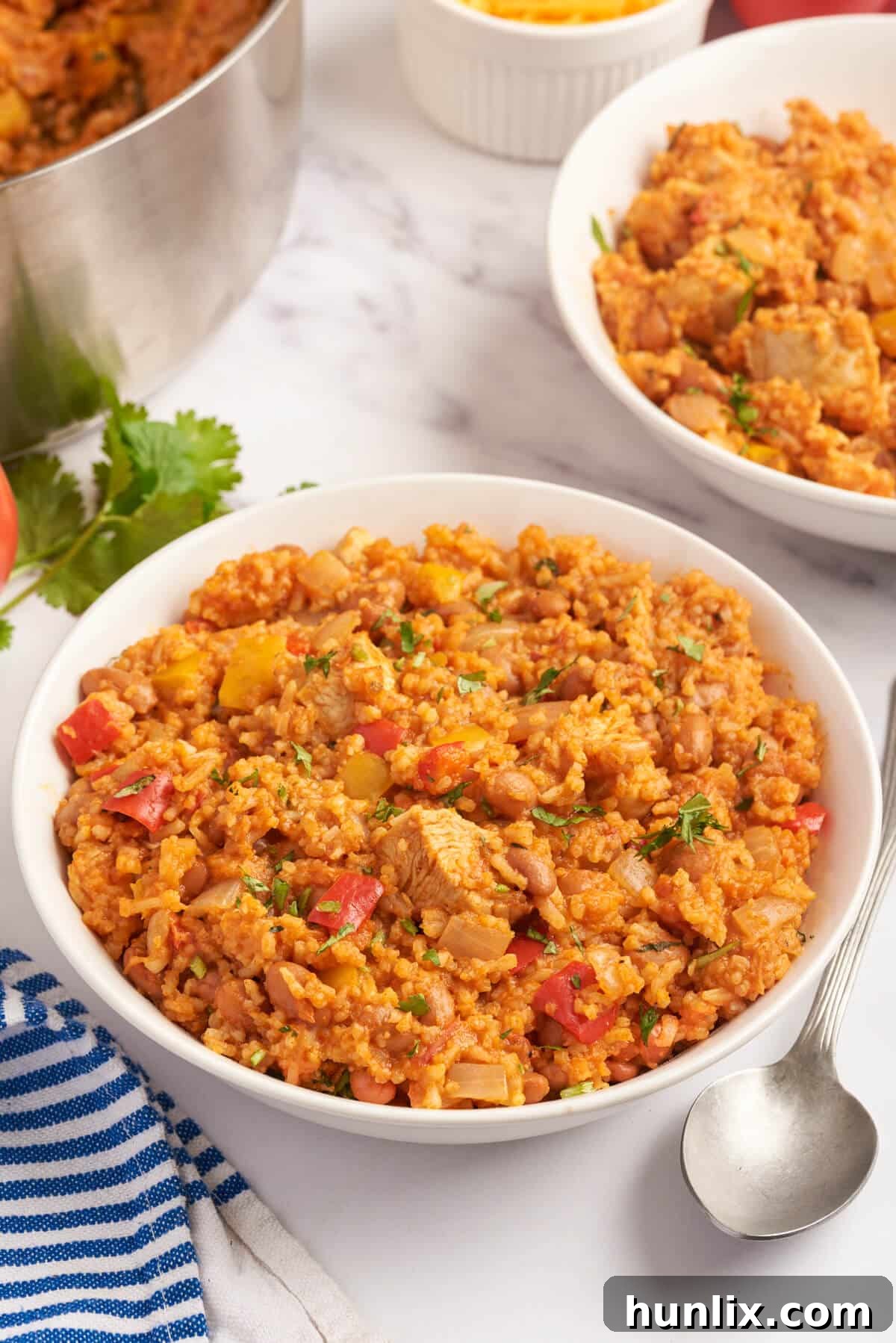 Skillet Chicken Burrito Fiesta 9 Close-up of a chicken burrito bowl in a white bowl, highlighting fresh ingredients and textures.