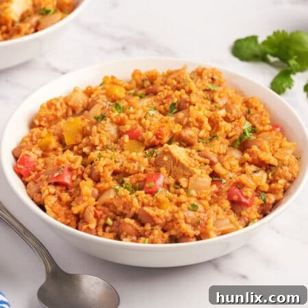 A vibrant chicken burrito bowl in a white serving dish.