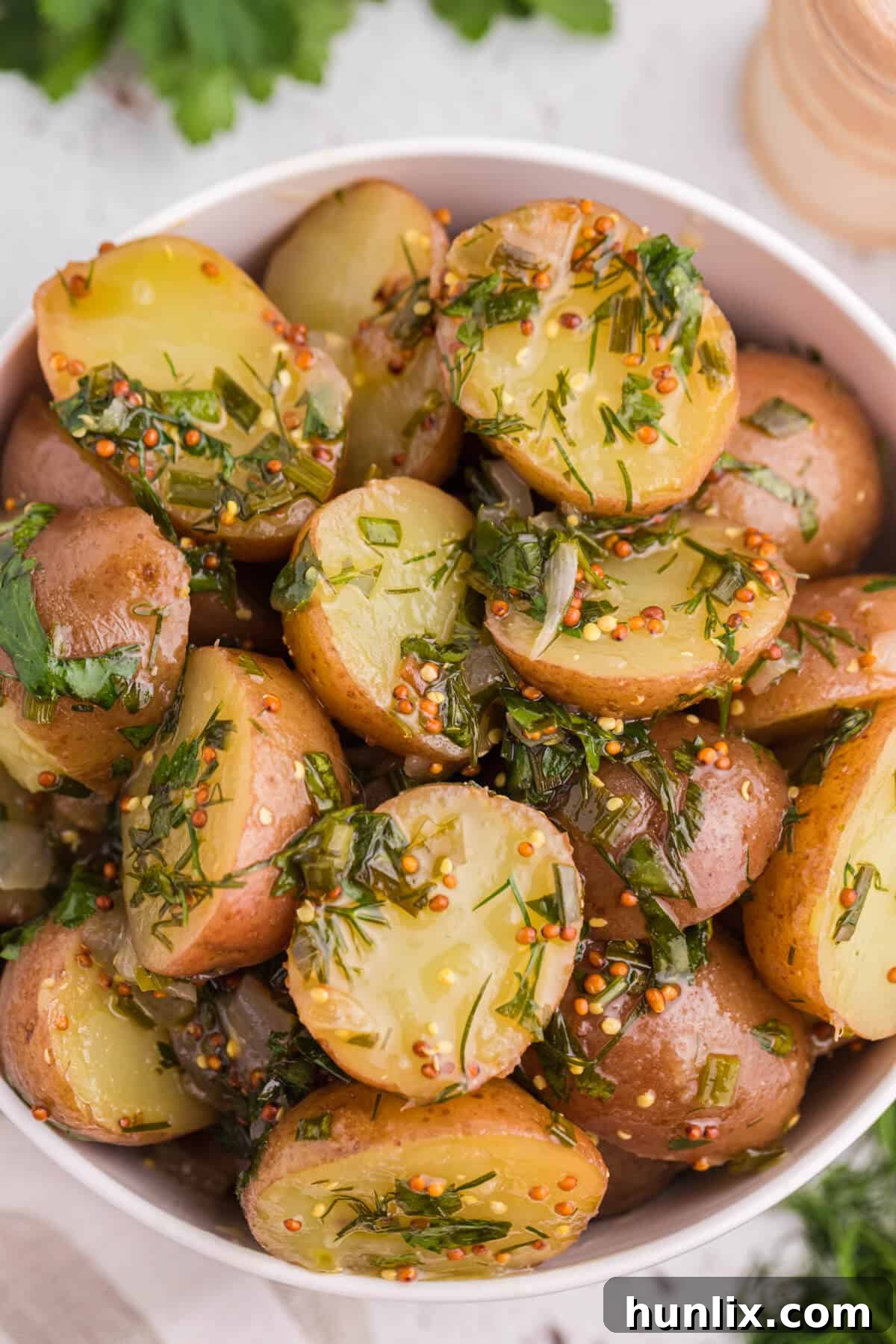 Vibrant Herb Potato Salad 2 Freshly prepared Herb Potato Salad in a beautiful serving bowl, garnished with extra herbs.