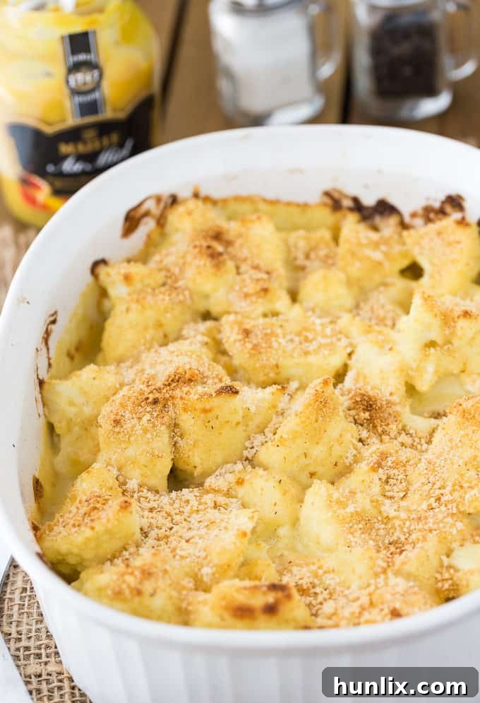 Honey Dijon Baked Cauliflower - This easy side dish is hearty enough for Meatless Monday! This cauliflower casserole recipe is super tangy and covered in breadcrumbs and Parmesan cheese. Yum!