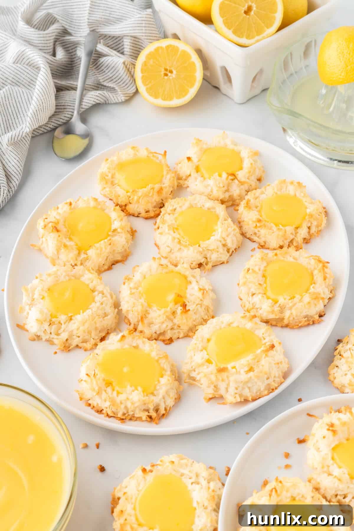 A selection of perfectly baked lemon curd coconut macaroons displayed on a white plate, highlighting their inviting texture.
