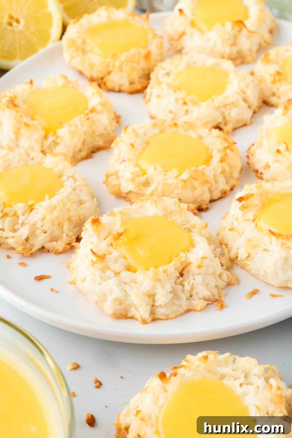 Lemon curd coconut macaroons carefully arranged on a plate, ready for serving or storing.