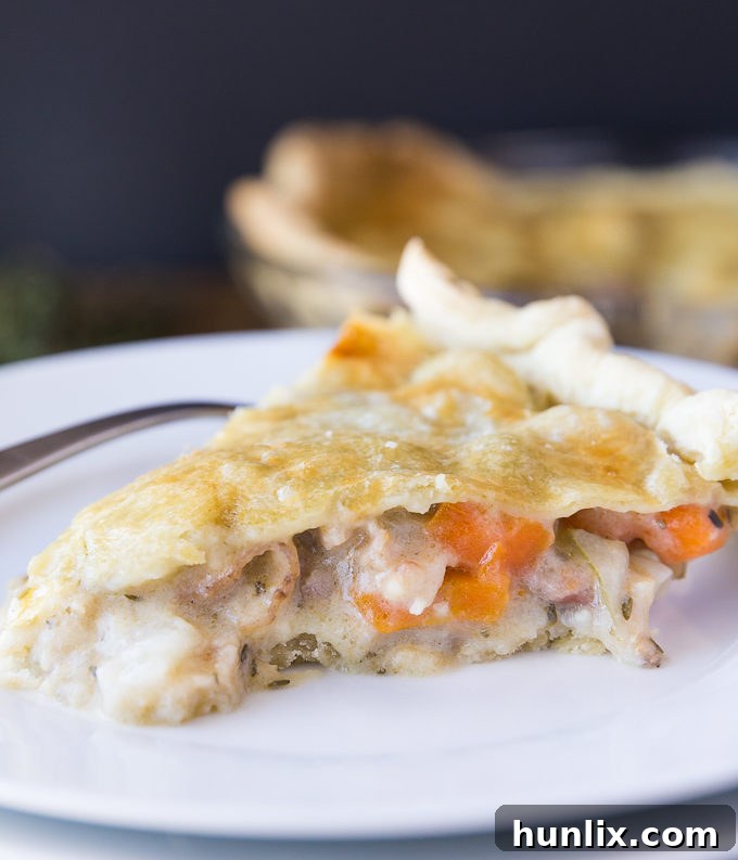 The rustic pie crust being pressed into a pie dish, highlighting its unique crumbly texture.