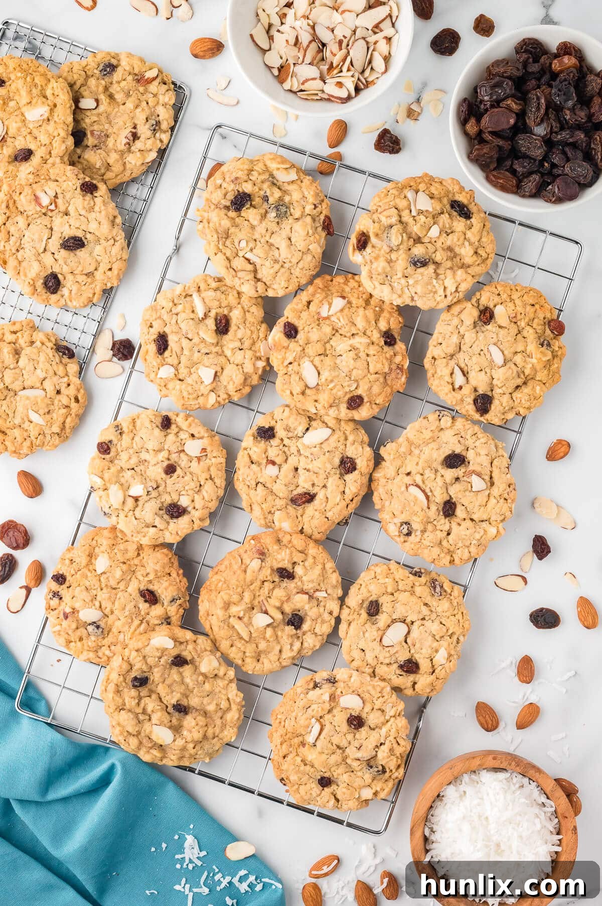 Hearty Trail Mix Oatmeal Cookies 2 Golden brown Trail Mix Oatmeal Cookies cooling on a wire rack, showcasing their hearty texture and delicious mix-ins.