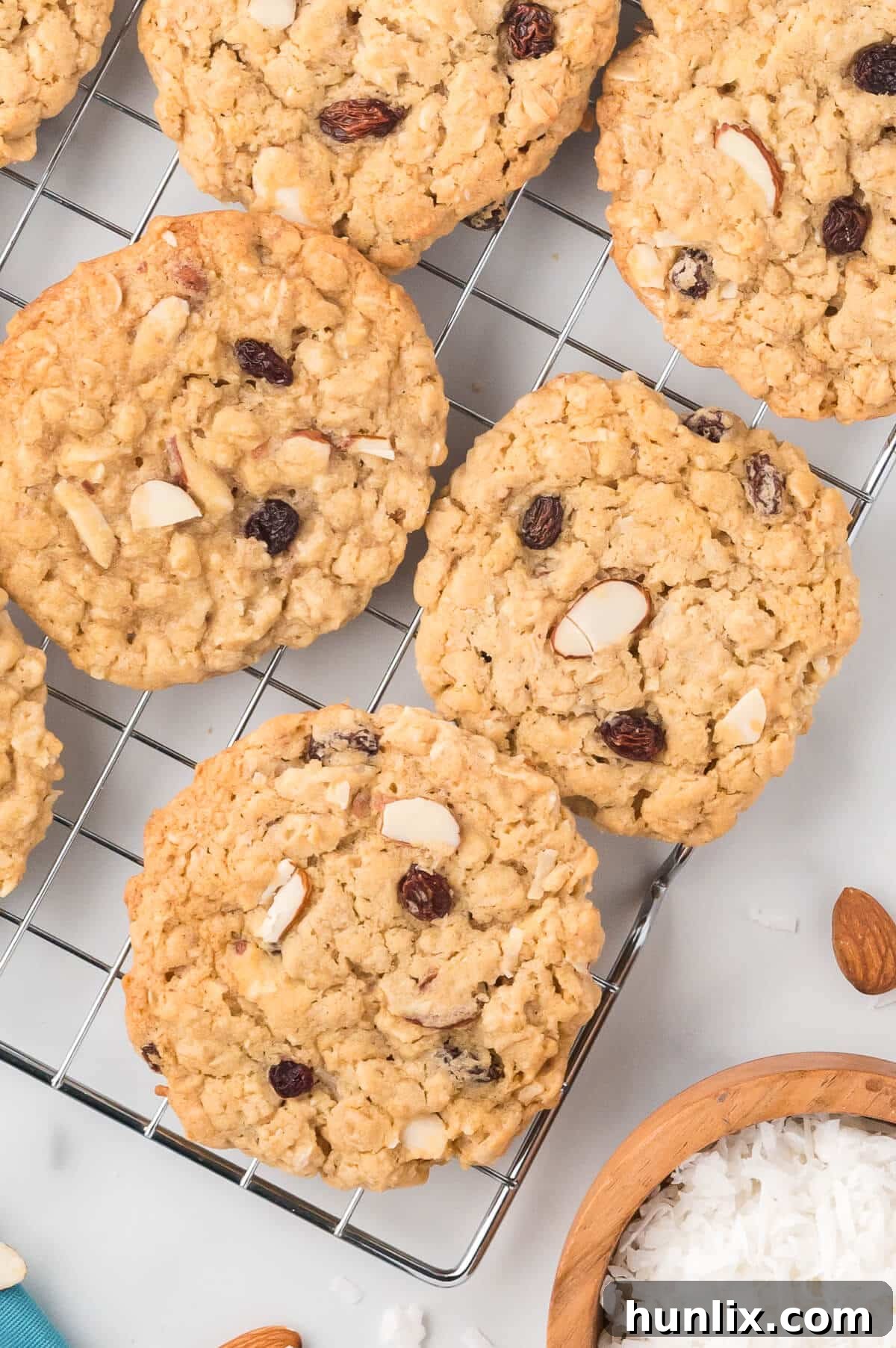 Hearty Trail Mix Oatmeal Cookies 10 A collection of Trail Mix Oatmeal Cookies neatly arranged on a wire cooling rack, highlighting their texture and appealing golden color.