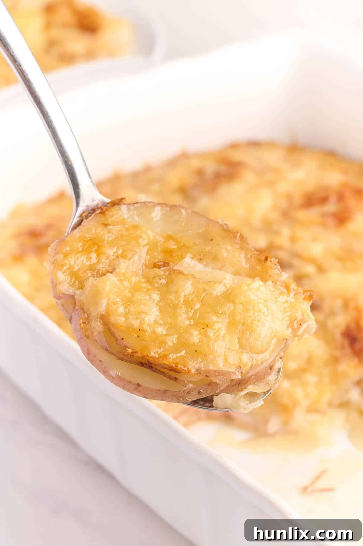 A serving spoon with Swiss Potatoes.