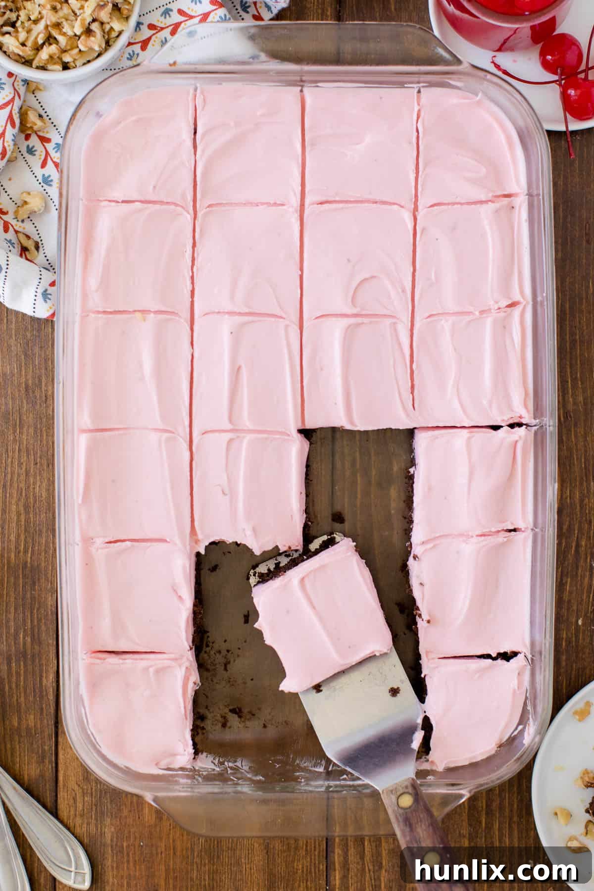 Fudgy Banana Split Brownies in a baking dish, perfectly cut into squares, with one piece being lifted by a spatula, revealing its luscious layers.