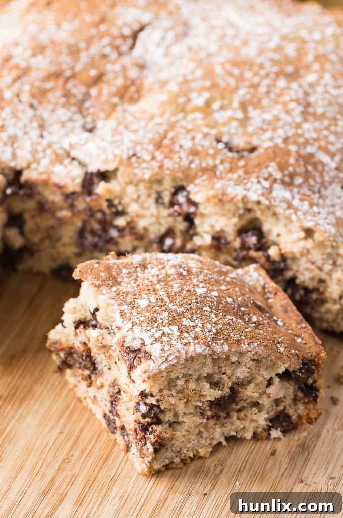 Close-up of a Banana Chocolate Cake slice with a fork, emphasizing its delightful texture.